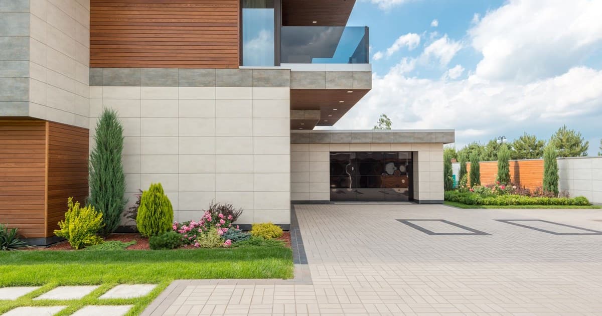 Modern double-storey house with lawn and paved driveway in Lahore