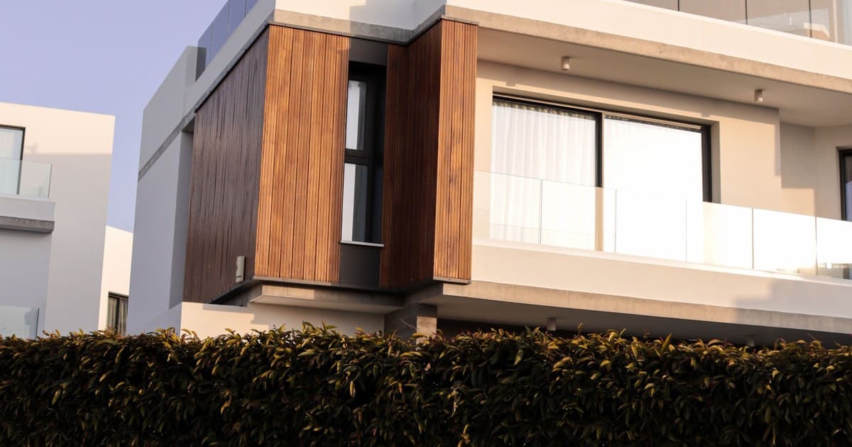 Modern residential villa with wooden cladding and rooftop terrace in DHA Lahore