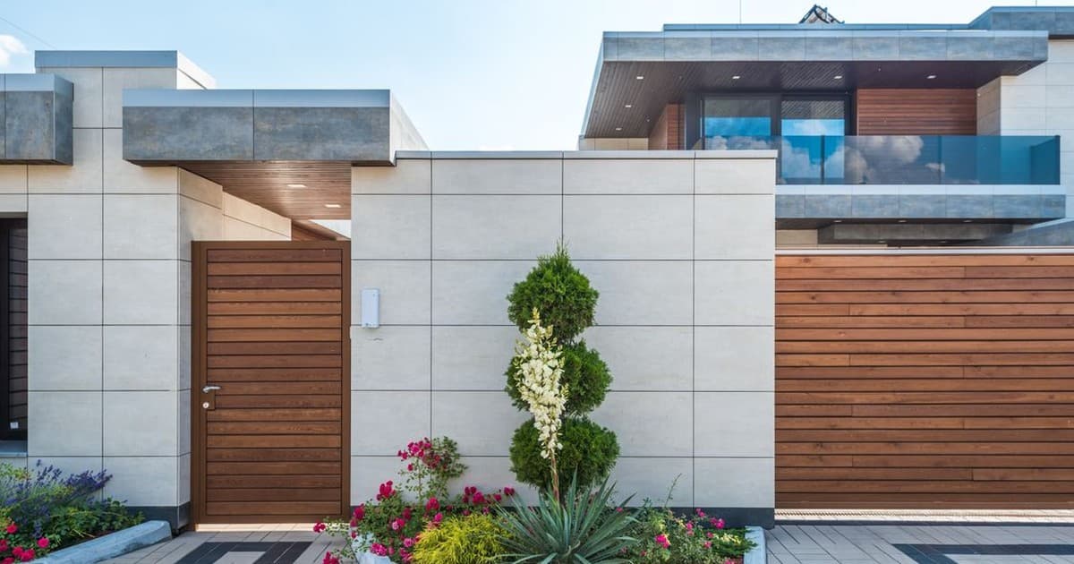 Modern house facade with wooden gate and landscaped entrance, typical of a rental investment property in a Lahore housing society