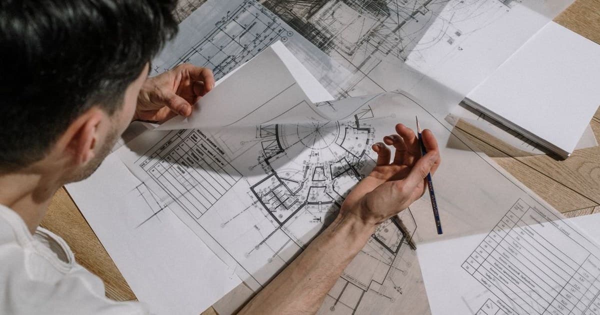 Architect reviewing house building plans on a desk