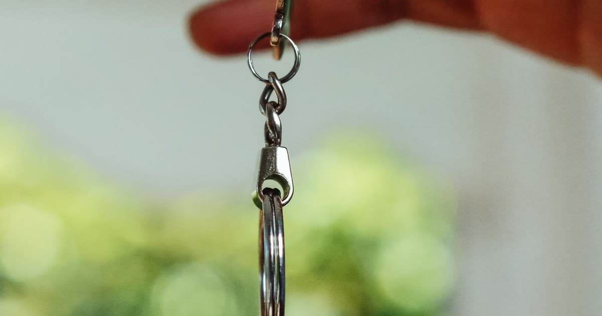 A hand holding a set of house keys, close up