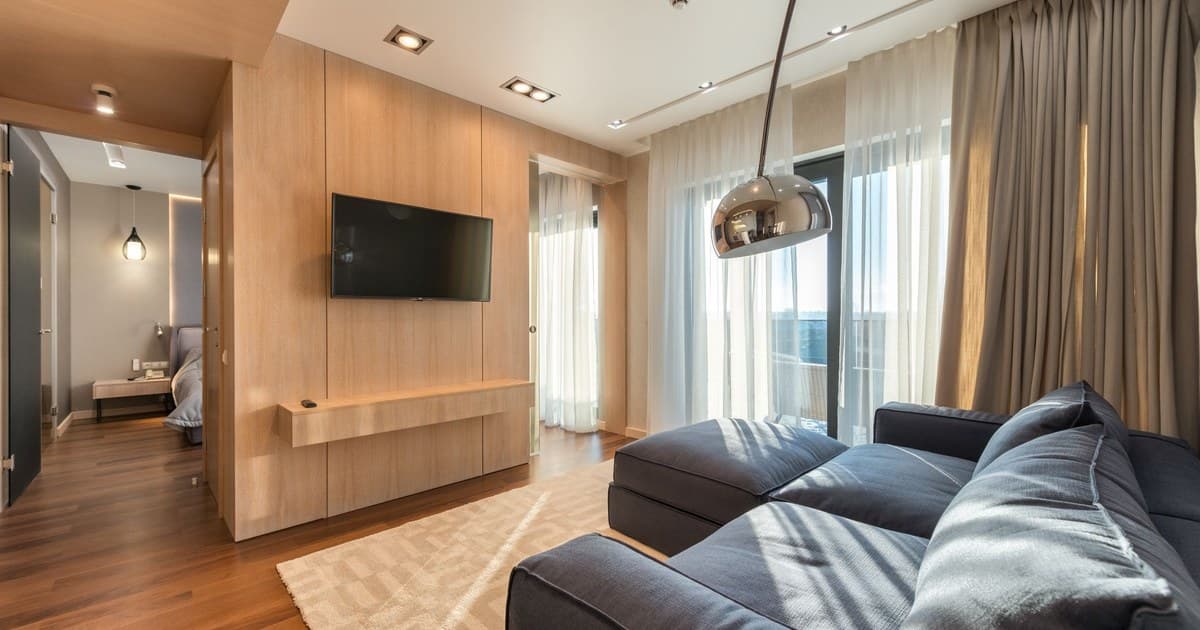 Furnished living room with a sofa and television in a rented Lahore apartment