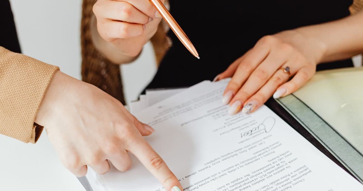 Two people reviewing property documents together on a desk